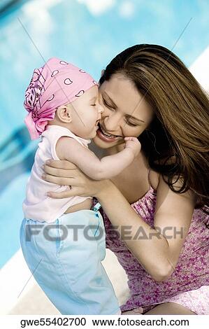 High angle view of a young woman holding her daughter View Large Photo Image Stock Image - High angle view of a young woman holding her daughter. Fotosearch