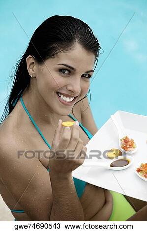 High angle view of a young woman holding a plate View Large Photo Image Stock Image - High angle view of a young woman holding a plate. Fotosearch