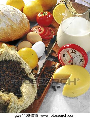 Stock Photo - High angle view of an alarm clock with food ingredients. Fotosearch