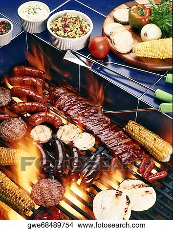 Picture - High angle view of assorted meats on a barbecue grill. Fotosearch