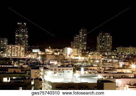 High angle view of buildings in a city lit up at night View Large Photo Image Stock Image - High angle view of buildings in a city lit up at night. Fotosearch