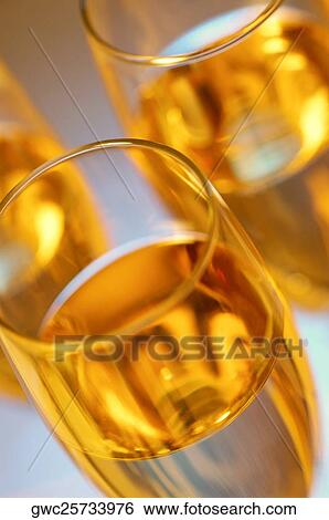 High angle view of champagne in three champagne flutes View Large Photo Image Stock Photograph - High angle view of champagne in three champagne flutes. Fotosearch