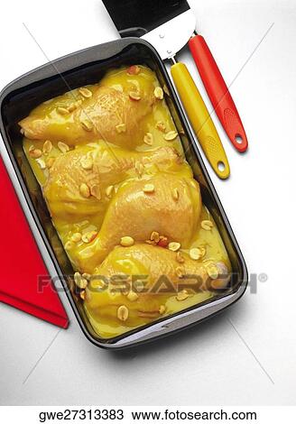 Stock Image - High angle view of chicken legs in a serving tray. Fotosearch