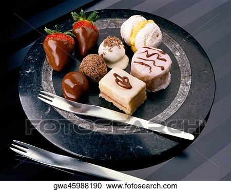 Stock Image - High angle view of chocolates and pastries on a plate. Fotosearch