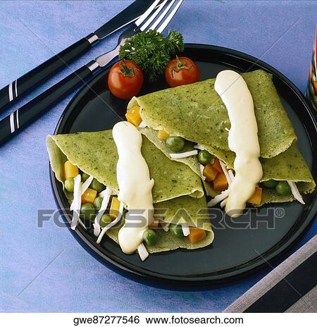 High angle view of crepes verdes on a plate View Large Photo Image Stock Photograph - High angle view of crepes verdes on a plate. Fotosearch