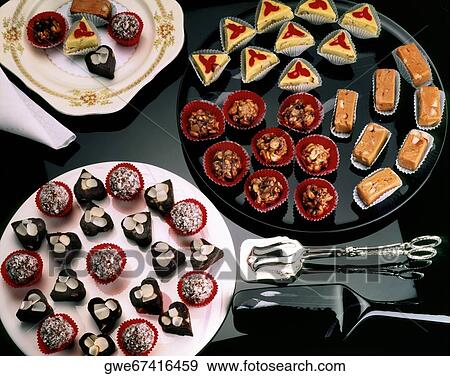 Stock Photo - High angle view of dulces on plates. Fotosearch