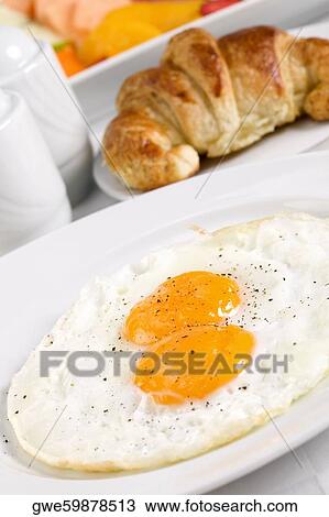 Stock Image - High angle view of fried eggs in a plate. Fotosearch