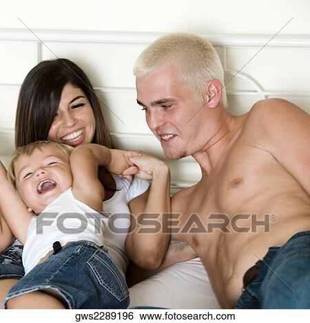 High angle view of parents playing with their son View Large Photo Image Stock Photograph - High angle view of parents playing with their son. Fotosearch