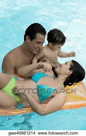 High angle view of parents with their son in a swimming pool View Large Photo Image Picture - High angle view of parents with their son in a swimming pool. Fotosearch