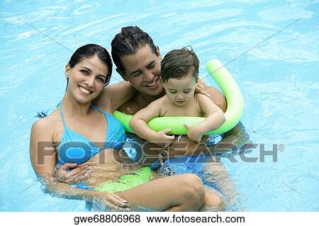 High angle view of parents with their son in a swimming pool View Large Photo Image Stock Photo - High angle view of parents with their son in a swimming pool. Fotosearch