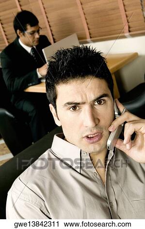 High angle view of two young businessmen working in an office View Large Photo Image Stock Image - High angle view of two young businessmen working in an office. Fotosearch