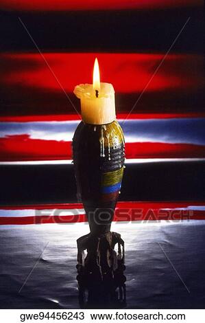 Lit candle on a candlestick holder View Large Photo Image Stock Image - Lit candle on a candlestick holder. Fotosearch