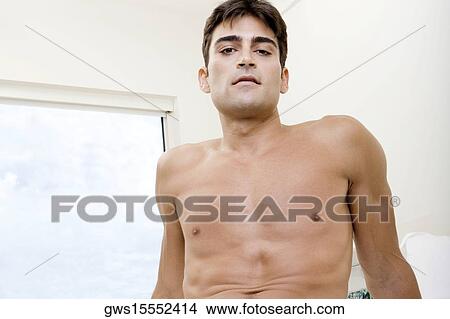 Low angle view of a mid adult man smirking View Large Photo Image Picture - Low angle view of a mid adult man smirking. Fotosearch