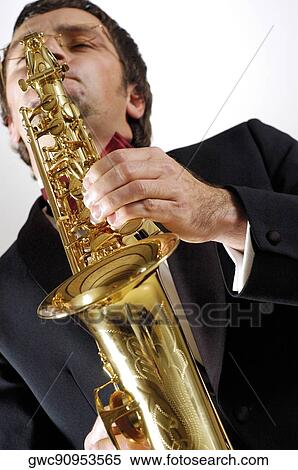 Low angle view of a musician playing the saxophone View Large Photo Image Stock Photography - Low angle view of a musician playing the saxophone. Fotosearch