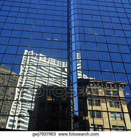 Stock Image - Low angle view of the reflection of buildings on a glass front, Boston, Massachusetts, USA. Fotosearch