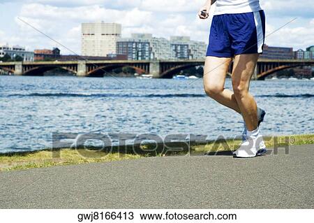 Low section view of a person jogging View Large Photo Image Stock Image - Low section view of a person jogging. Fotosearch
