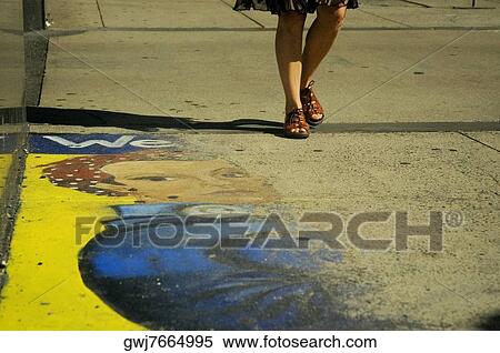 Low section view of a woman walking on the sidewalk View Large Photo Image Stock Photography - Low section view of a woman walking on the sidewalk. Fotosearch