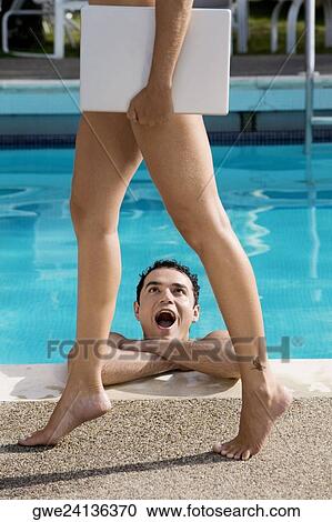 Low section view of a young woman carrying a laptop with a young man looking at her in a swimming pool View Large Photo Image Stock Image - Low section view of a young woman carrying a laptop with a young man looking at her in a swimming pool. Fotosearch