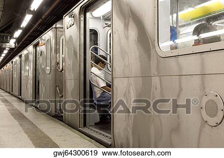 Man sitting in a train at a subway station, New York City, New York State, USA View Large Photo Image Stock Photo - Man sitting in a train at a subway station, New York City, New York State, USA. Fotosearch
