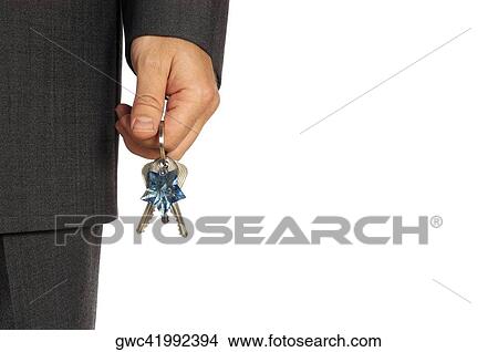 Picture - Mid section view of a businessman holding keys. Fotosearch