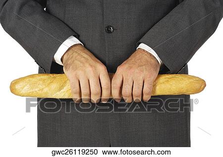 Stock Image - Mid section view of a businessman holding a loaf of bread. Fotosearch