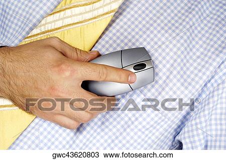 Stock Image - Mid section view of a businessman holding a computer mouse. Fotosearch