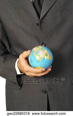 Stock Photo - Mid section view of a businessman holding a globe. Fotosearch