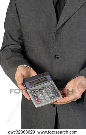 Mid section view of a businessman holding a calculator View Large Photo Image Stock Photo - Mid section view of a businessman holding a calculator. Fotosearch