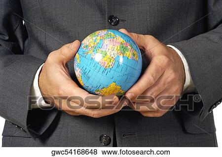 Stock Photo - Mid section view of a businessman holding a globe. Fotosearch
