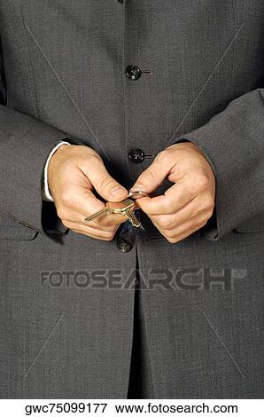 Mid section view of a businessman holding keys View Large Photo Image Stock Photo - Mid section view of a businessman holding keys. Fotosearch