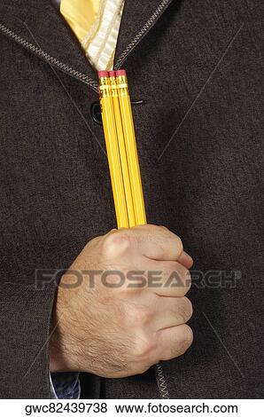 Stock Photo - Mid section view of a businessman holding three pencils. Fotosearch