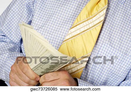 Mid section view of a businessman holding paper currency View Large Photo Image Stock Photography - Mid section view of a businessman holding paper currency. Fotosearch