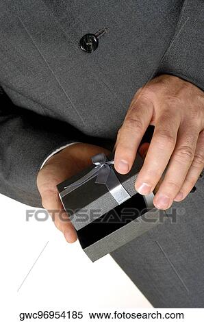 Mid section view of a businessman holding a gift View Large Photo Image Stock Photography - Mid section view of a businessman holding a gift. Fotosearch