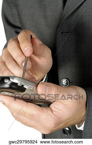 Picture - Mid section view of a businessman using a personal data assistant. Fotosearch
