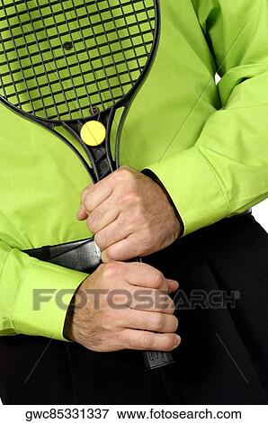 Stock Photo - Mid section view of a man holding a tennis racket. Fotosearch