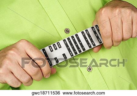 Mid section view of a man holding a remote control View Large Photo Image Stock Photograph - Mid section view of a man holding a remote control. Fotosearch