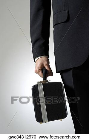 Mid section view of a musician holding a case View Large Photo Image Stock Image - Mid section view of a musician holding a case. Fotosearch
