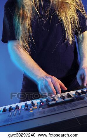 Mid section view of a musician playing the synthesizer View Large Photo Image Stock Image - Mid section view of a musician playing the synthesizer. Fotosearch