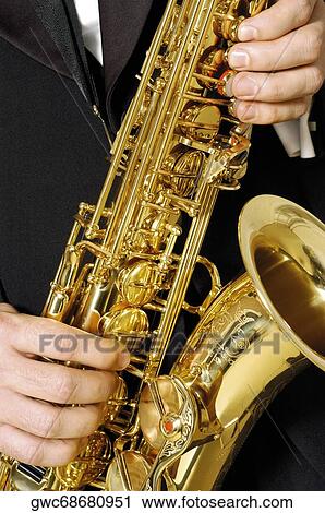 Mid section view of a musician playing the saxophone View Large Photo Image Stock Image - Mid section view of a musician playing the saxophone. Fotosearch