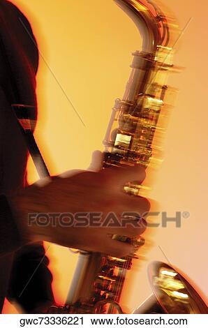 Mid section view of a musician playing the saxophone View Large Photo Image Stock Image - Mid section view of a musician playing the saxophone. Fotosearch