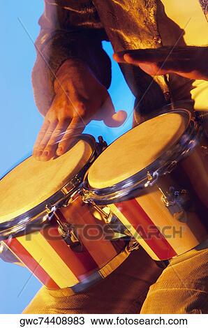 Mid section view of a musician playing the bongo View Large Photo Image Stock Image - Mid section view of a musician playing the bongo. Fotosearch