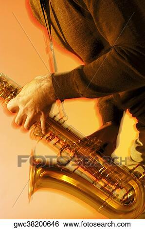 Mid section view of a musician playing the saxophone View Large Photo Image Stock Photograph - Mid section view of a musician playing the saxophone. Fotosearch