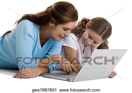 Stock Image - Mother and her daughter working on a laptop. Fotosearch