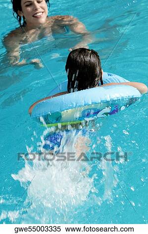 Mother with her daughter in a swimming pool View Large Photo Image Stock Photography - Mother with her daughter in a swimming pool. Fotosearch