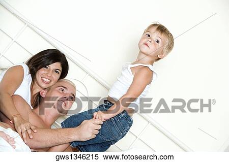 Stock Photography - Parents playing with their son. Fotosearch
