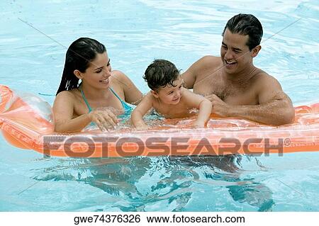 Parents with their son in a swimming pool View Large Photo Image Stock Photograph - Parents with their son in a swimming pool. Fotosearch