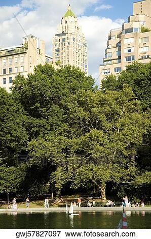 Stock Photo - People walking beside a lake, New York City, New York State, USA. Fotosearch