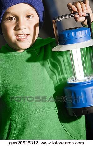 Portrait of a boy holding a lantern View Large Photo Image Stock Image - Portrait of a boy holding a lantern. Fotosearch