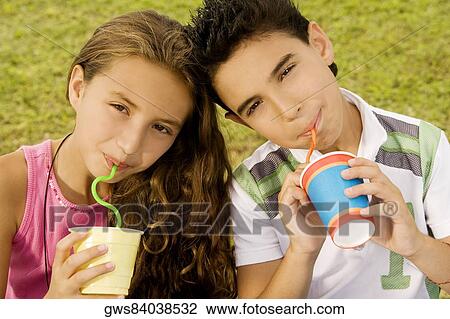 Portrait of a brother and sister drinking with straws View Large Photo Image Stock Image - Portrait of a brother and sister drinking with straws. Fotosearch