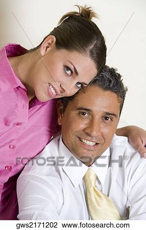 Stock Image - Portrait of a businessman and a businesswoman smiling. Fotosearch